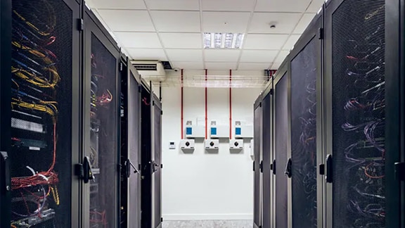 Interior view of a datacenter with rows of server racks
