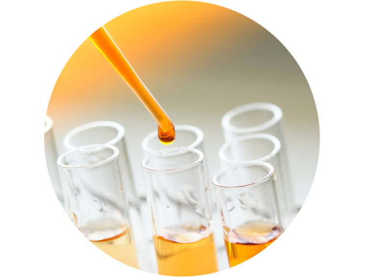 Dropper dispensing a yellow liquid into a test tube
