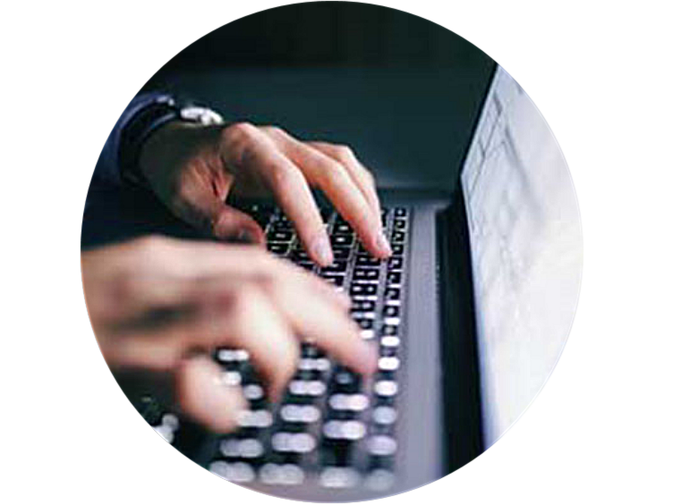 Close up of hands of a man working on laptop