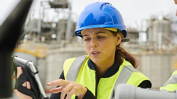 A lady looking at the tab in construction sites